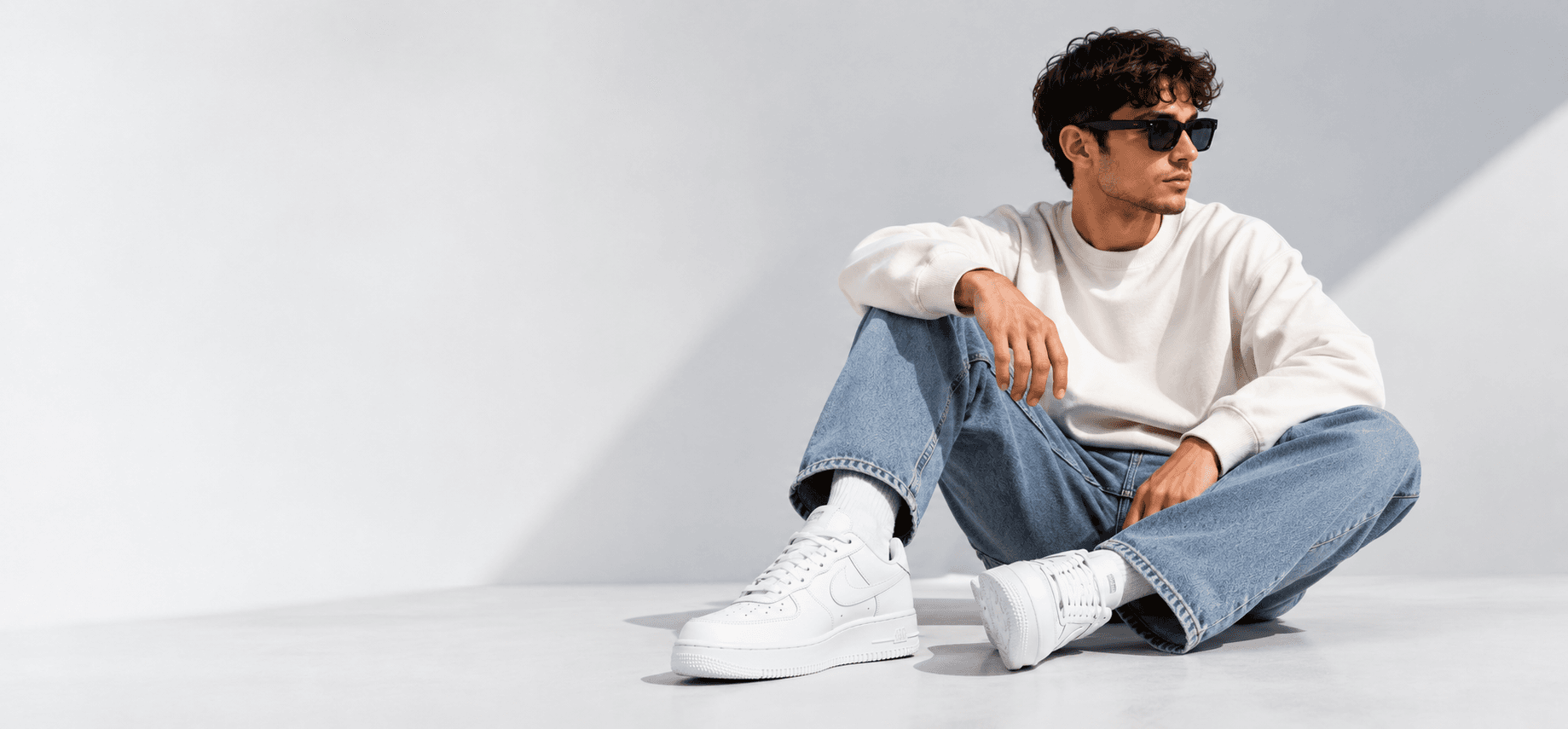 Model wearing Velora sweatshirt seated